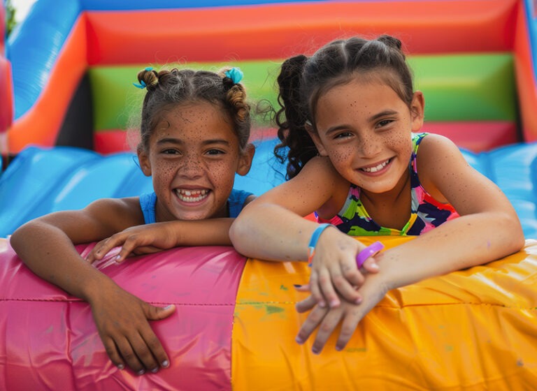 two-happy-children-relaxing-large-inflatable-bounce-house